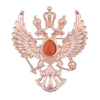 Broche aigle d'empire en métal doré avec pierre centrale orange en forme de goutte, motif à double tête couronnée