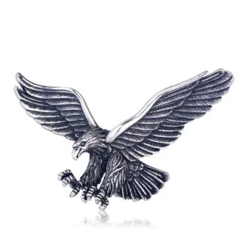 Broche aigle vintage en métal argenté avec ailes déployées et détails soignés