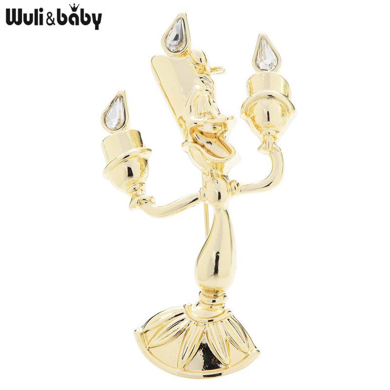 Broche bougeoir dorée à trois branches avec détails en forme de goutte transparente