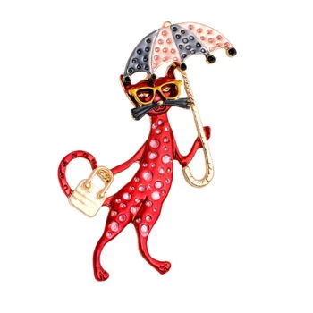 Broche chat rouge en métal émaillé avec lunettes jaunes, tenant un parapluie noir et blanc à pois et un sac à main doré