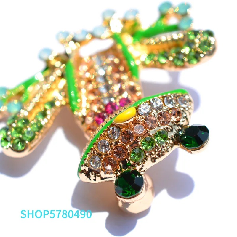 Broche grenouille originale en métal doré avec strass verts, jaunes et roses, détail du visage et des yeux en strass verts foncés