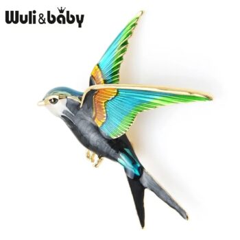 Broche hirondelle colorée en métal avec ailes déployées bleu vert et détails dorés