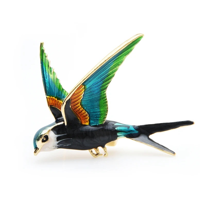 Broche hirondelle colorée en métal émaillé avec ailes déployées montrant des détails soignés et finition élégante