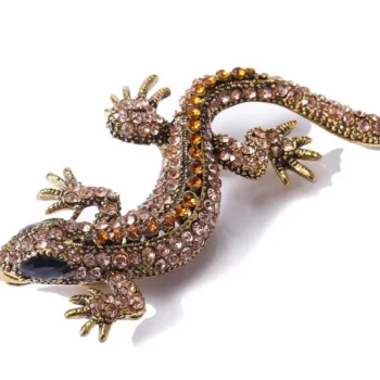 Broche lézard strass couleur bronze avec détails en strass orange et finition soignée