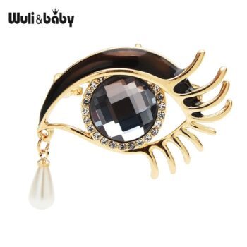 Broche œil femme dorée avec pierre facettée noire, strass et perle pendante