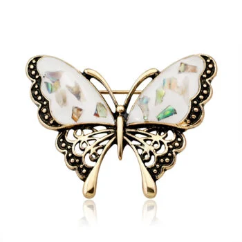 Broche papillon rétro en métal doré avec ailes ornées d'incrustations nacrées et détails ajourés noirs