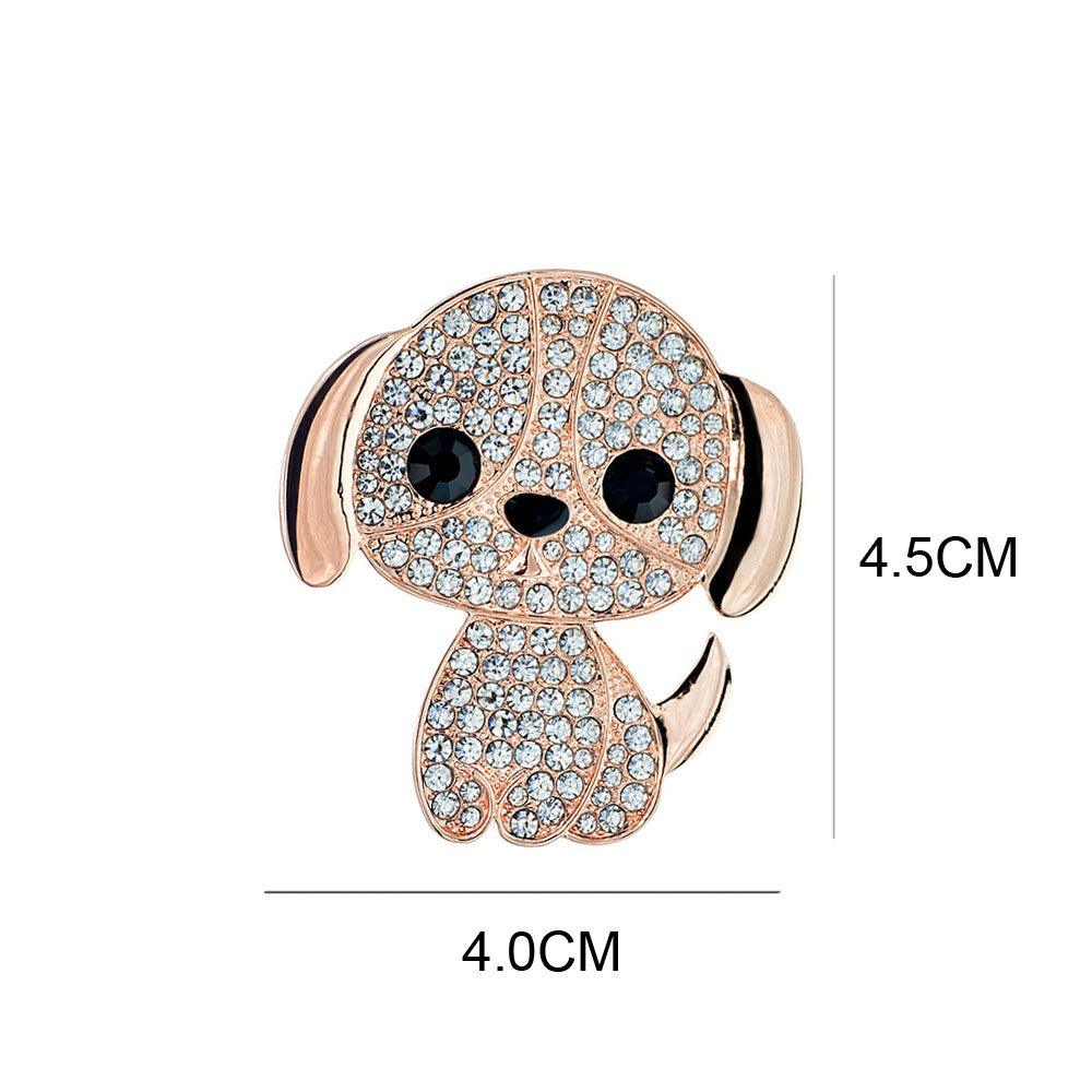 Broche petit chien strass couleur or rose avec yeux noirs, vue de face avec dimensions 4 cm sur 4,5 cm