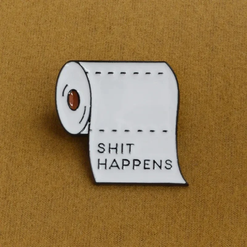 Pin's rouleau de papier toilette blanc avec inscription noire SHIT HAPPENS