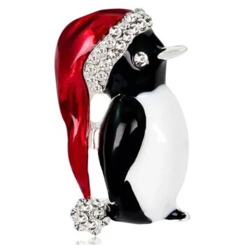 Broche pingouin noir et blanc avec bonnet de Noël rouge orné de strass brillants