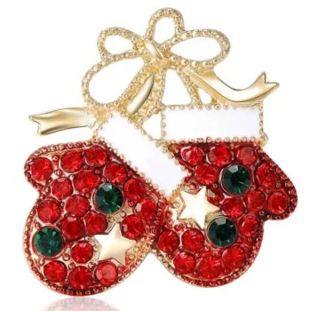 Broche gants de Noël en métal doré avec strass rouges et verts, détail étoile dorée, design travaillé et finition soignée