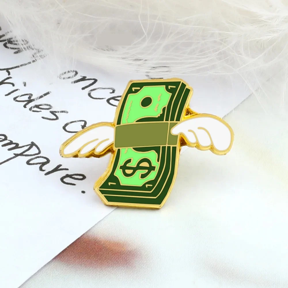 Pin's Dollars en métal doré avec design billet vert ailé